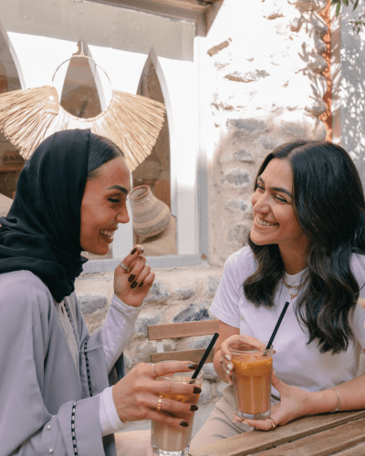 two women having iced coffees