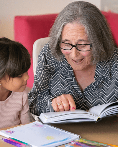 Woman reading with a young girl